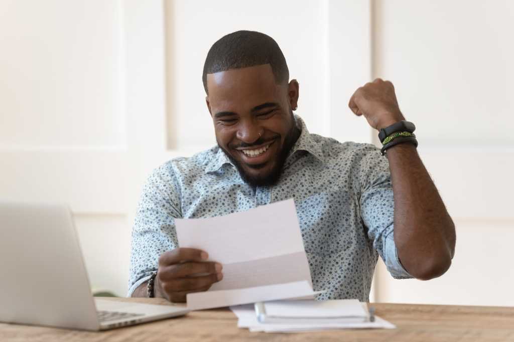 Smiling man celebrates certification award.